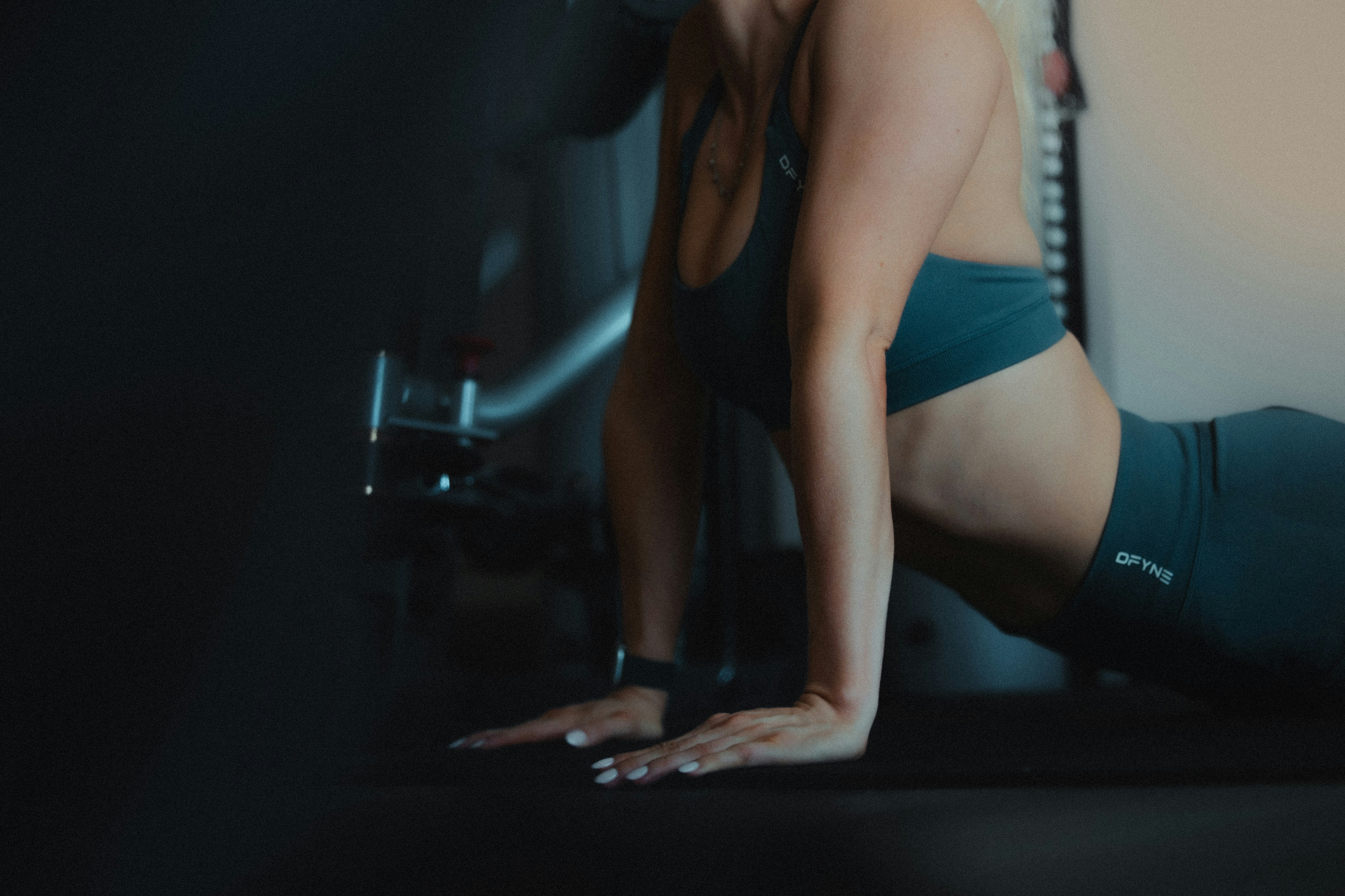 A small, dark flask is nestled among twigs and leaves on a forest floor, with a muted, mysterious ambiance.