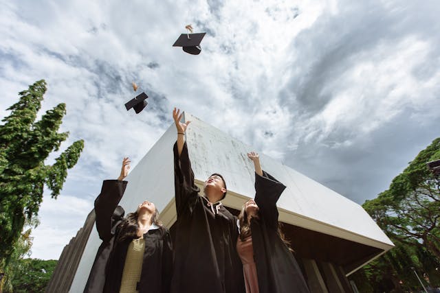 students throwing their graduation caps in the air