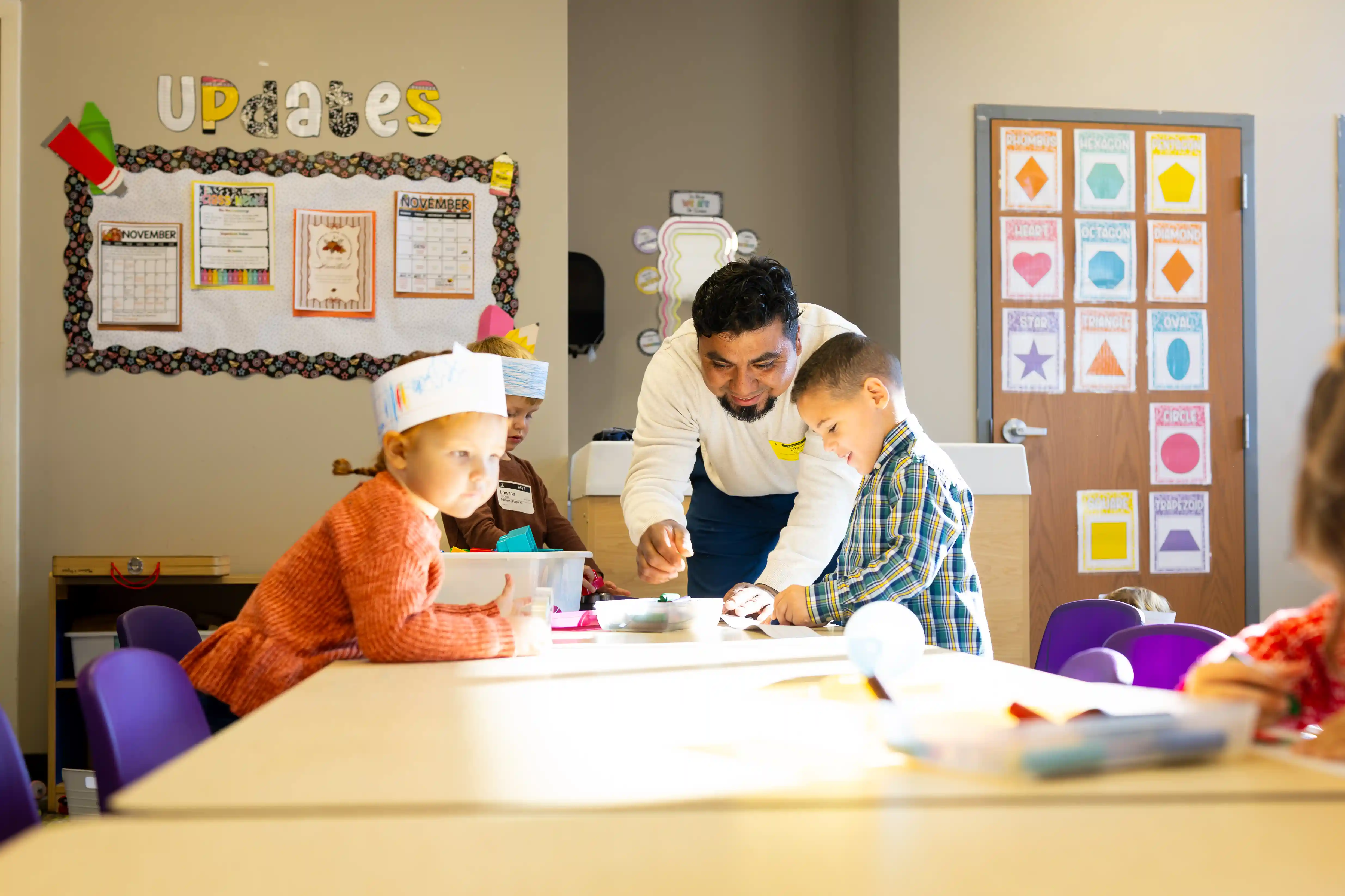 Lil Kids male volunteer helping with crafts