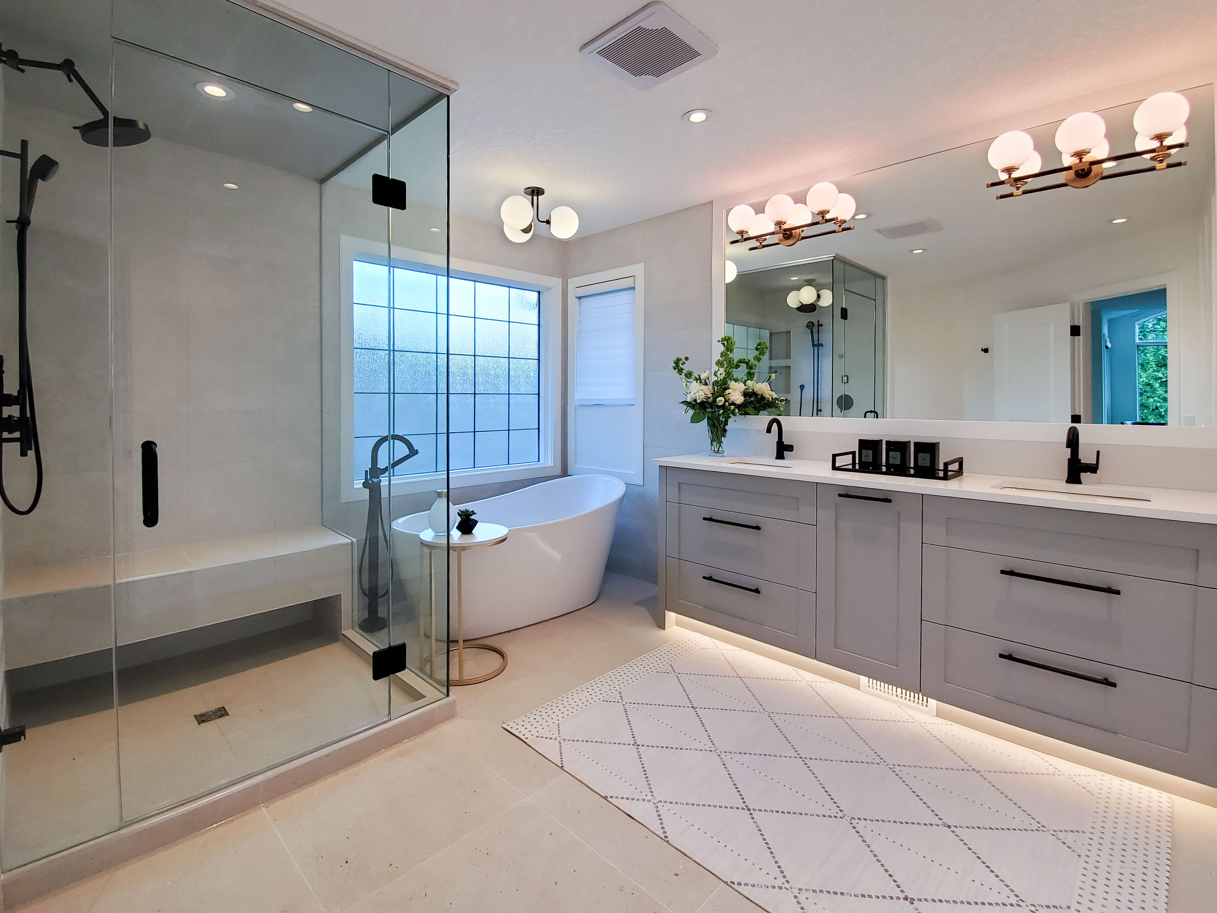 Image of Luxurious primary ensuite bathroom with modern design, spacious shower, freestanding tub, and double vanity by KHD Homes.