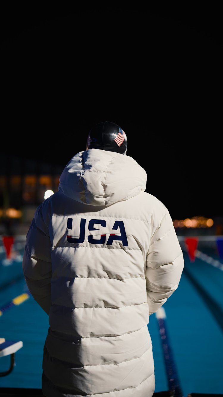 A high-detail shot of an athlete mentally and physically preparing, emphasizing the discipline behind ice swimming.