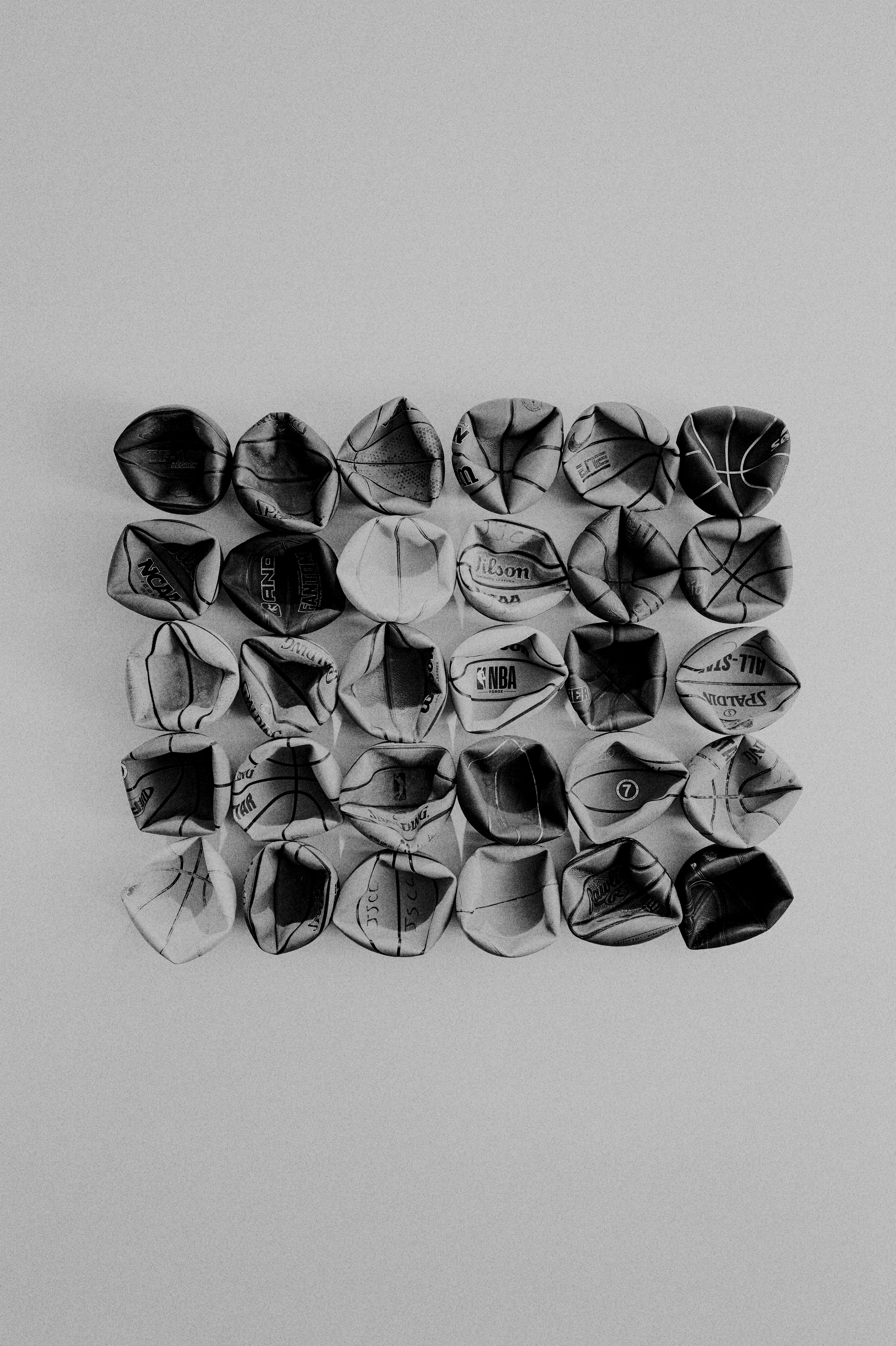 Crumpled paper balls arranged in a grid pattern.
