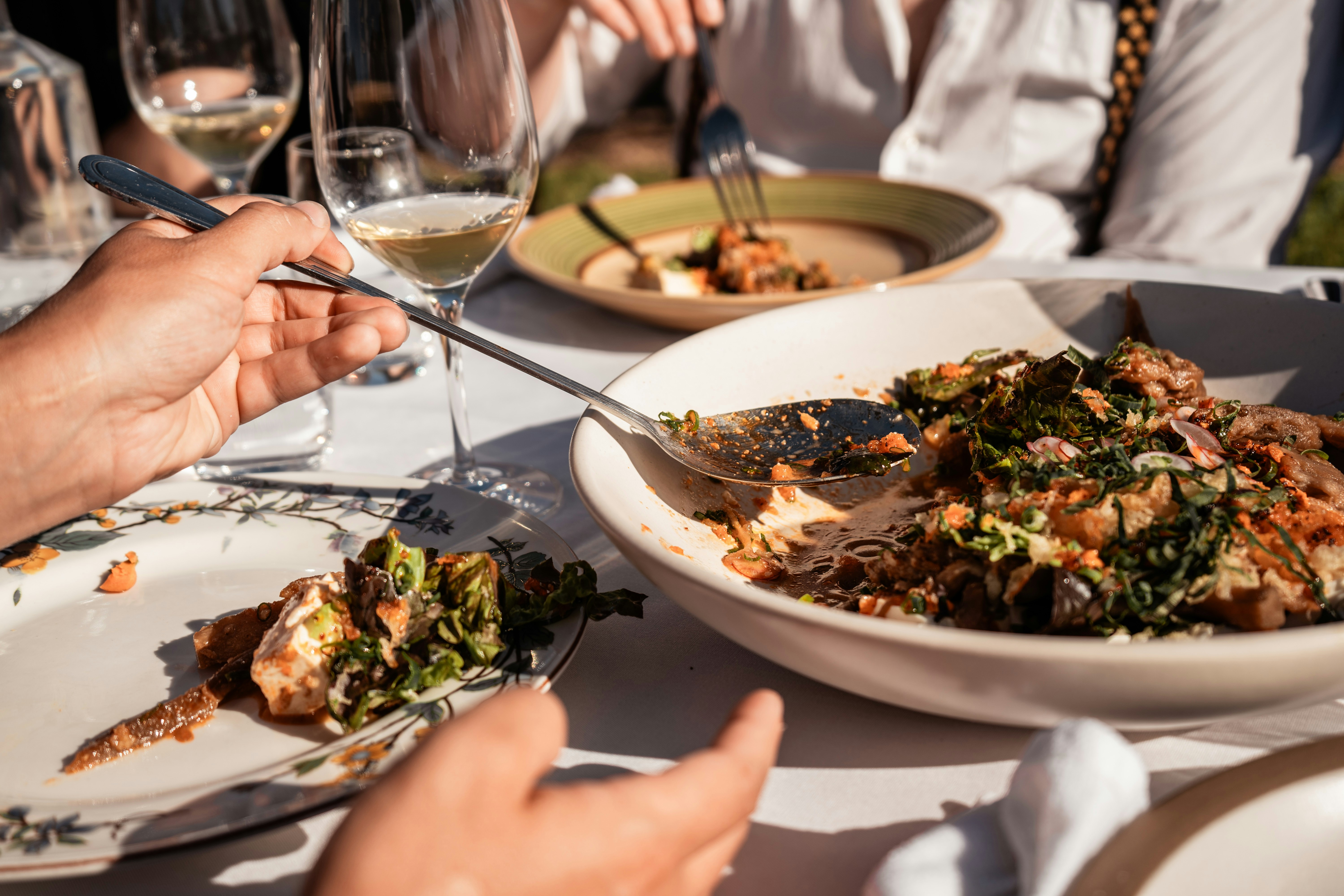 A group of people sitting at a table with plates of food