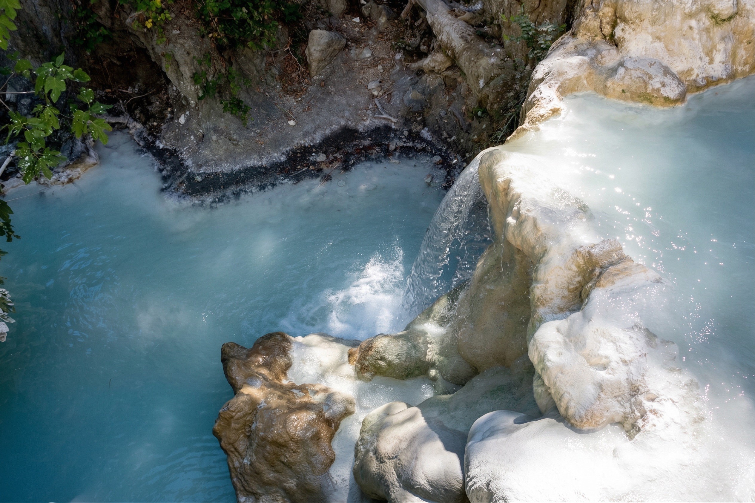 Petriolo natural hot spring pools in a forested gorge, Val di Farma, Tuscany