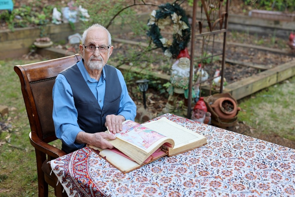 Bubjan with book and speaking to camera
