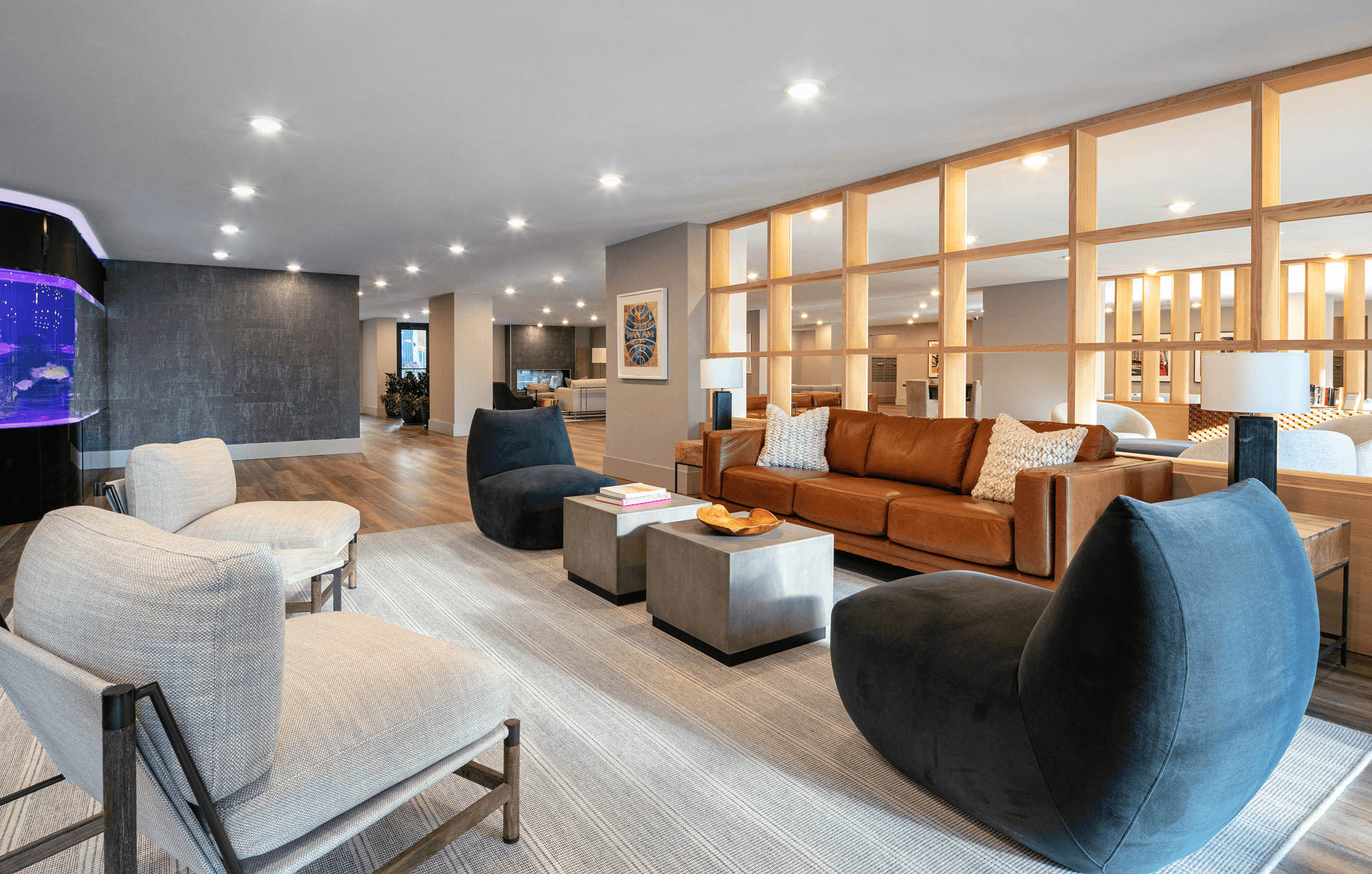 Modern living room featuring stylish furniture, wooden accents, and soft lighting, creating a cozy atmosphere.