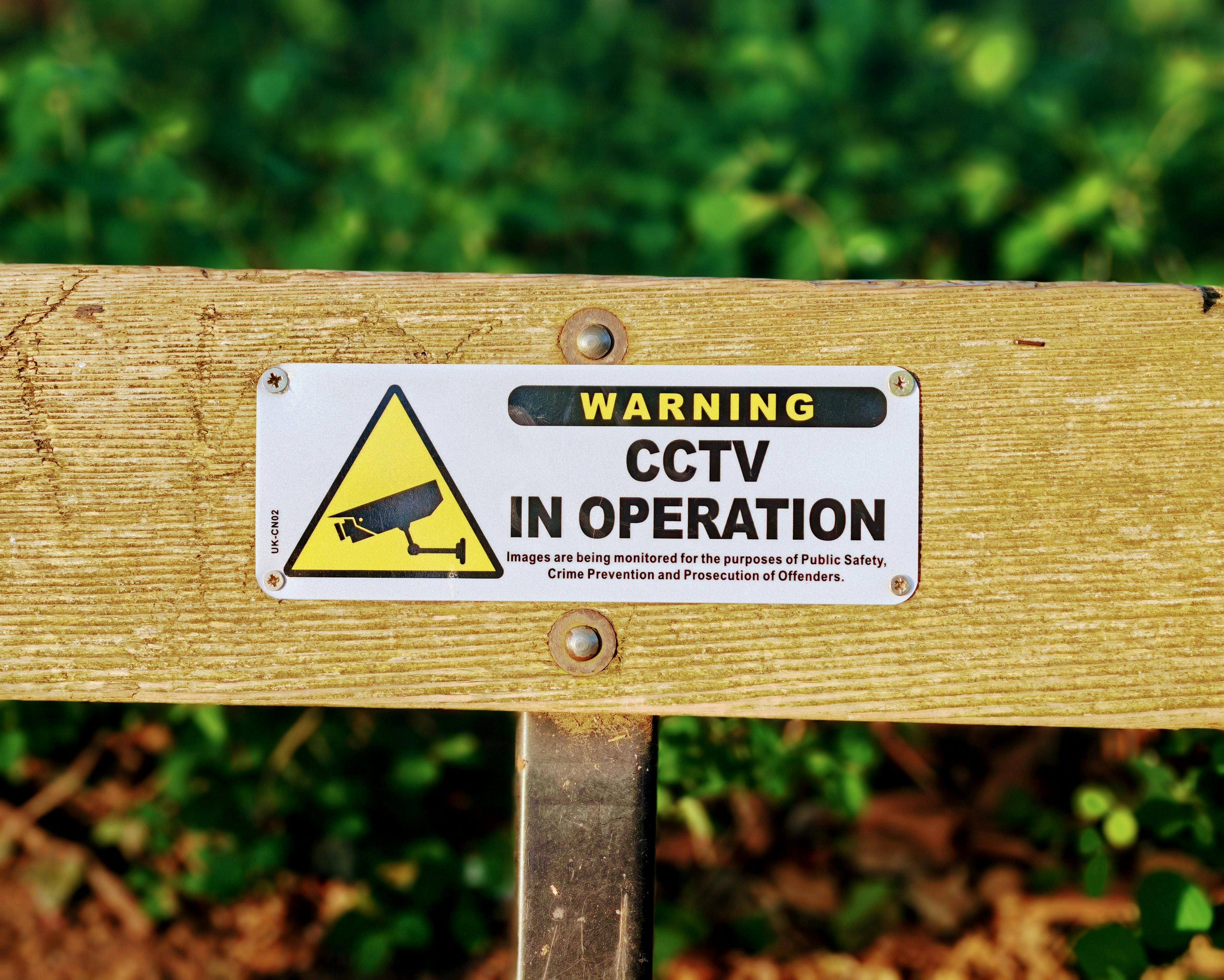 wooden-bench-with-a-cctv-in-operation-warning-sign,-emphasizing-public-safety. - george-morina (pexels)