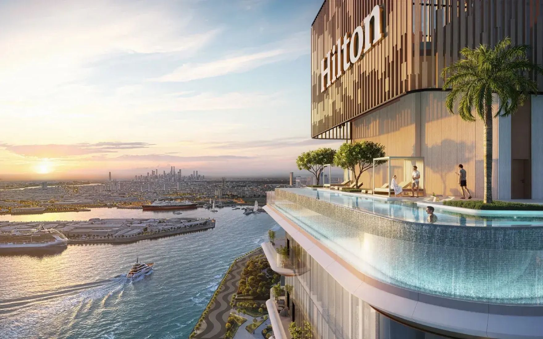 Rooftop infinity pool at Hilton Residences overlooking the harbor and city, with a few people enjoying the sunset view.