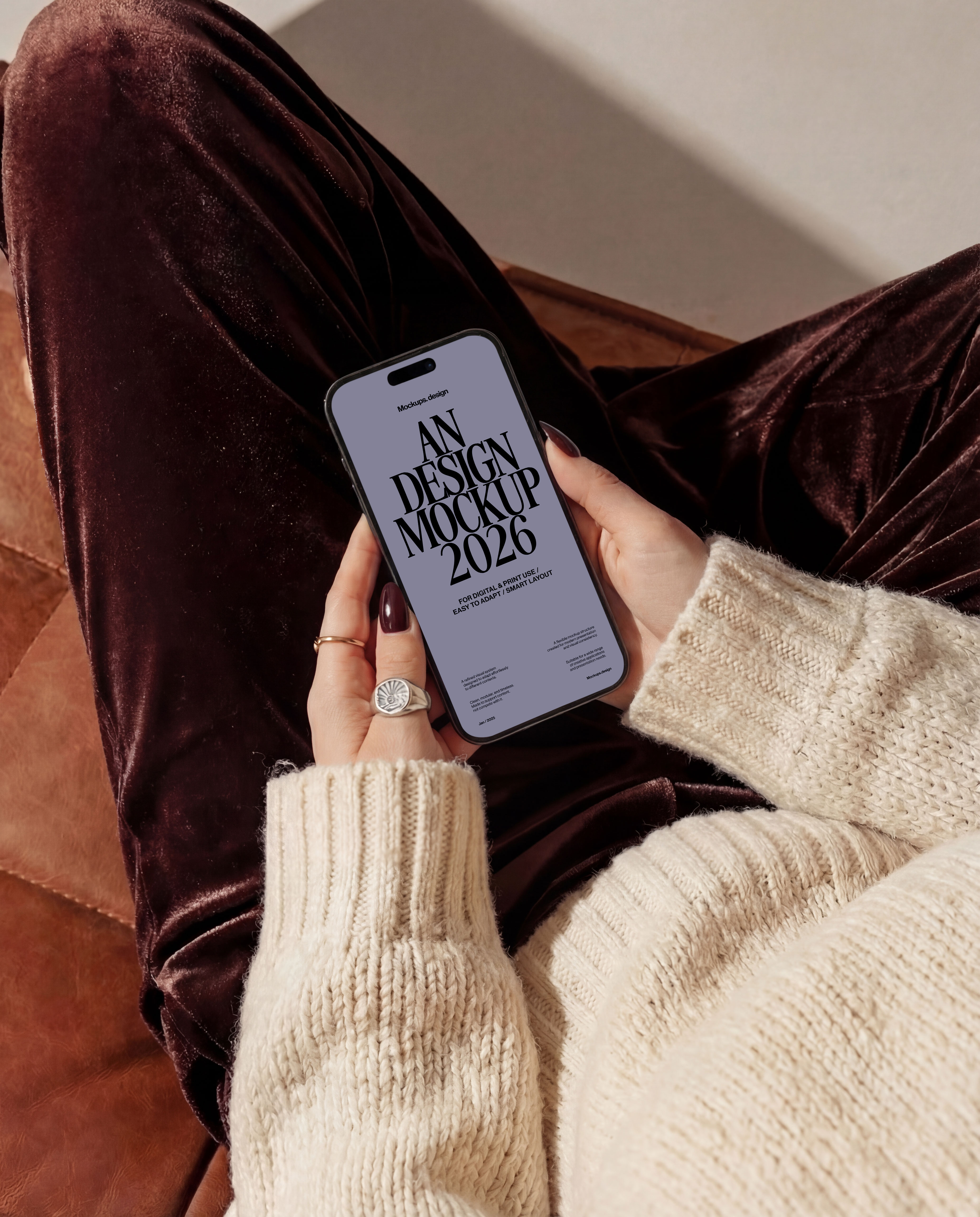 Woman holding iPhone 16 mockup on couch, natural home setting