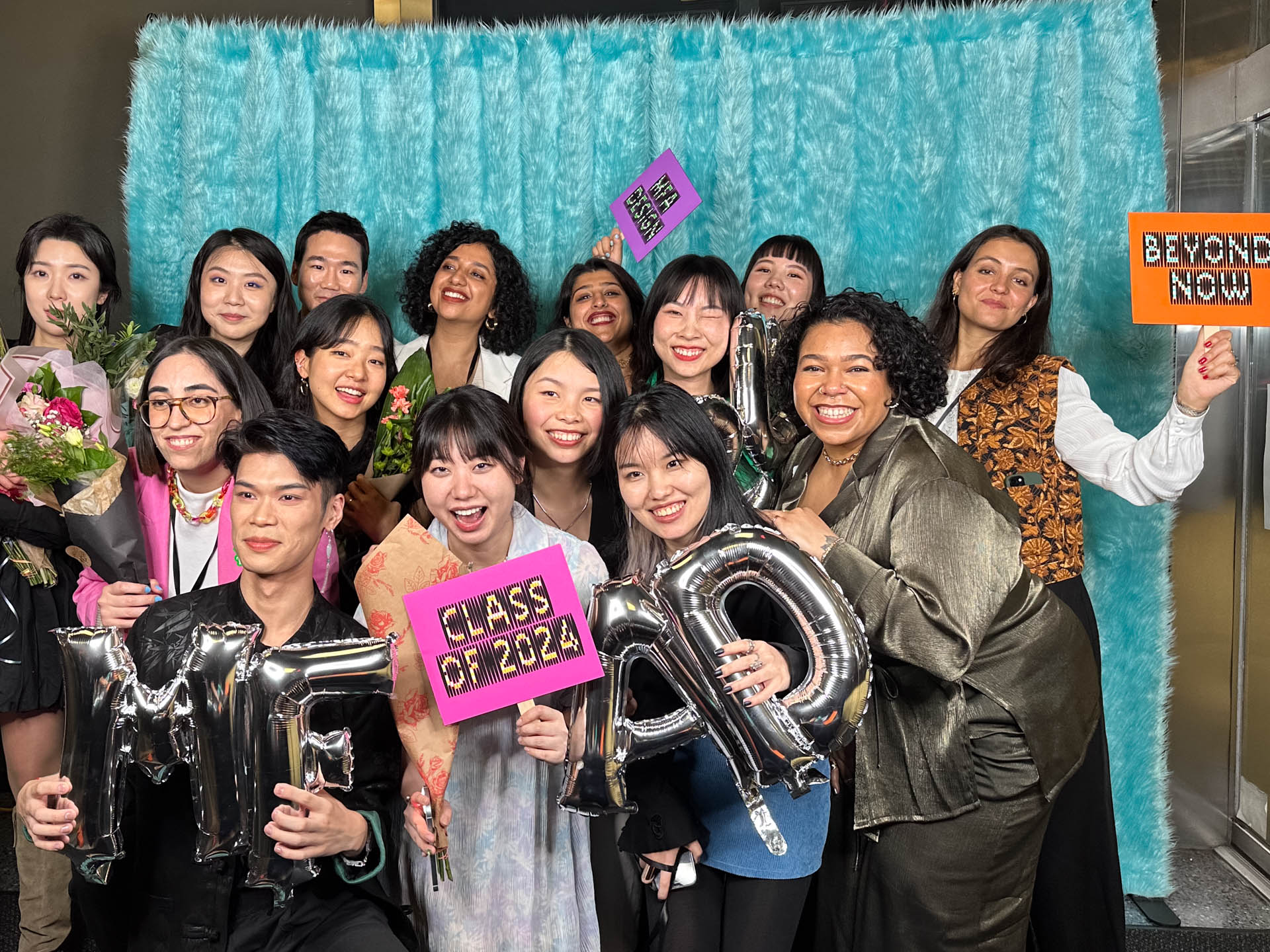 a group of students smiling for the camera in the SVA Theatre lobby after the Venture Forum