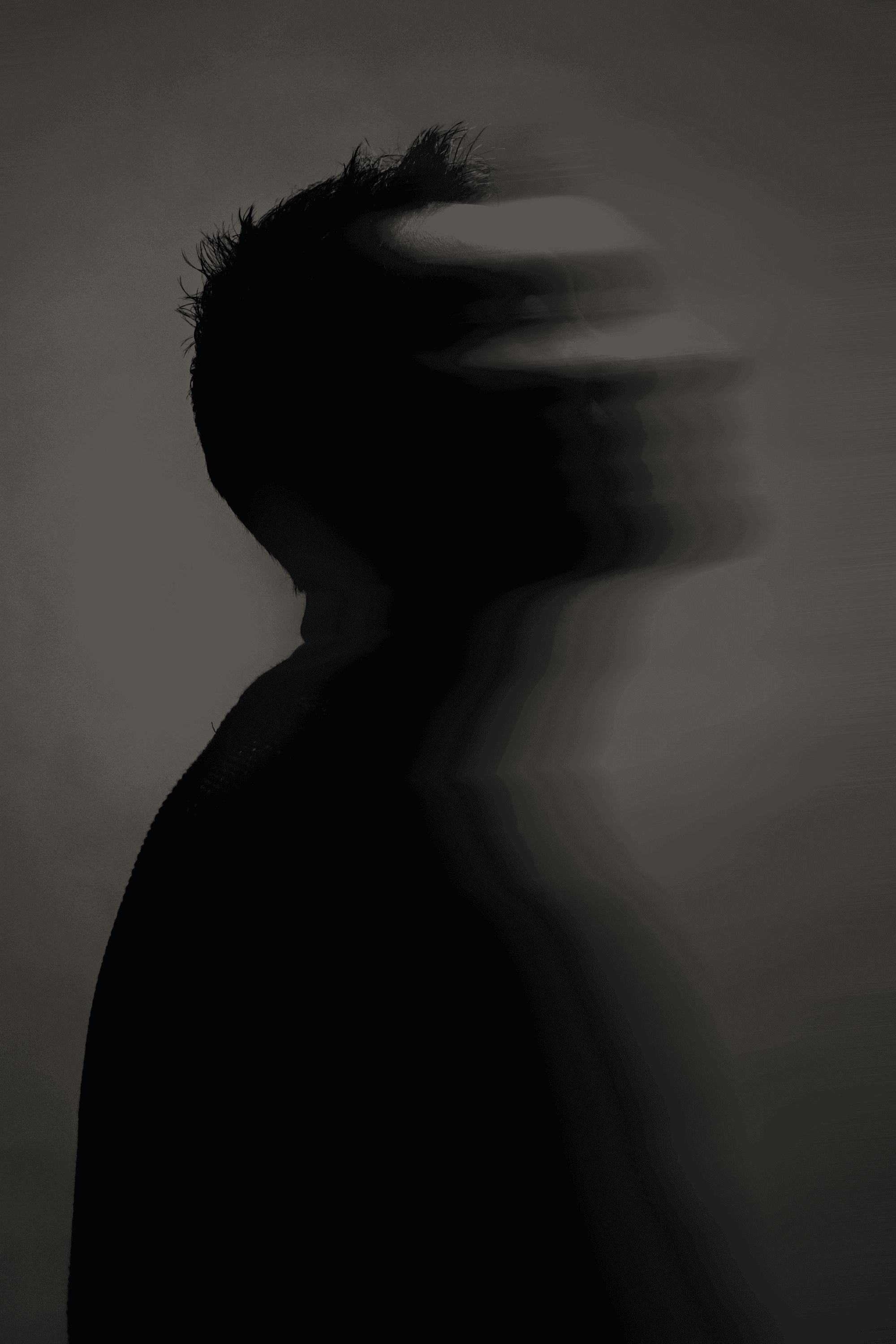 Silhouette of a person with blurred face in profile.