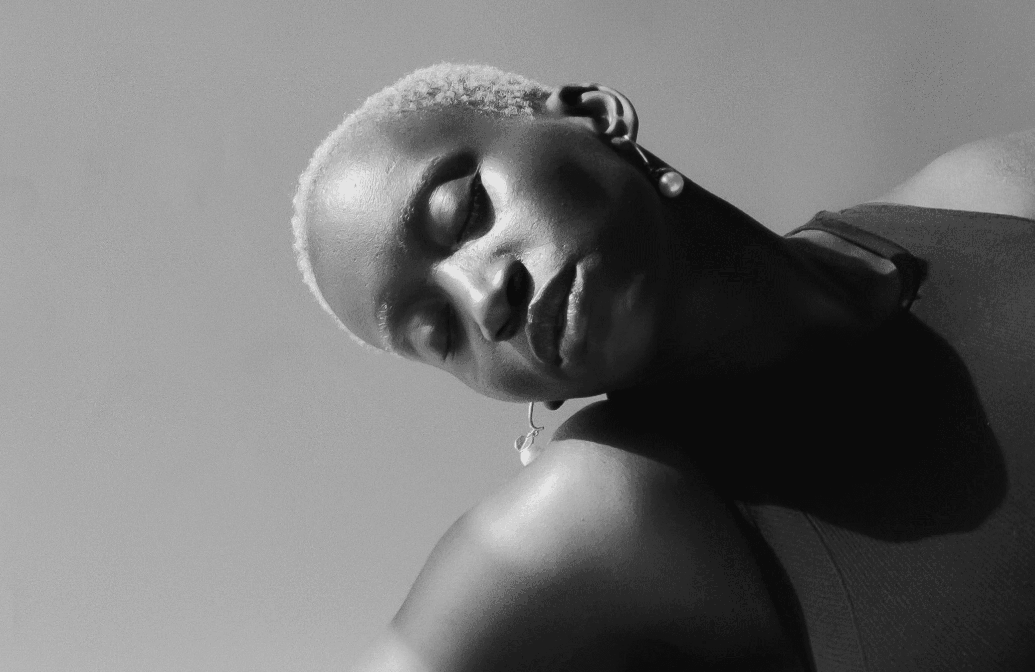 a black and white photo of a woman laying down