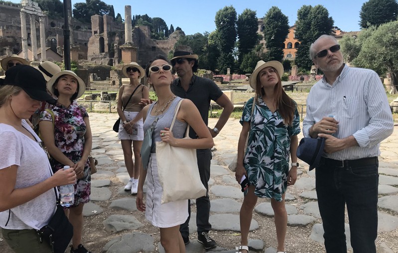 A photo of a group of people visiting some ancient ruins in Rome.