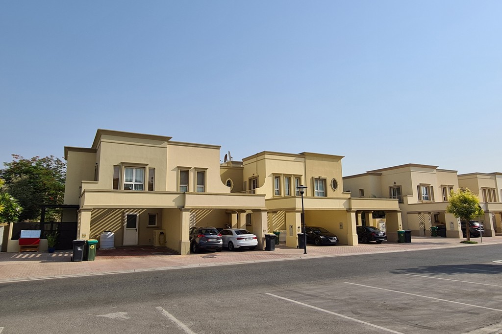 Front view of a spacious house with a car parked outside, marked "Springs 15."