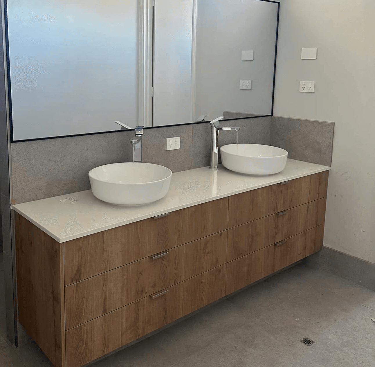 Electrician drilling in a wall