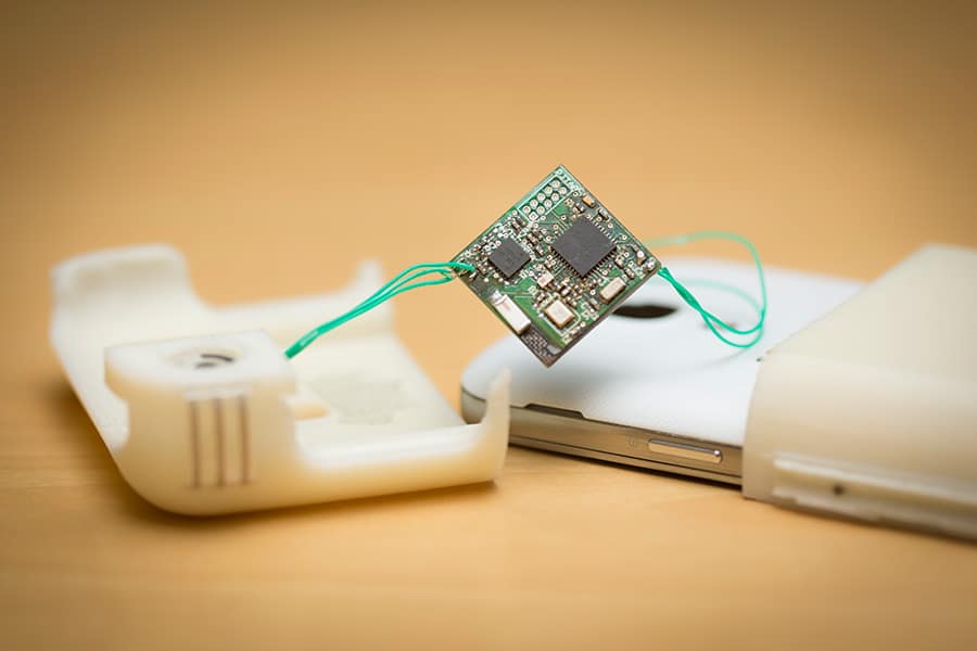 a white phone with a phone case in two parts and a computer chip