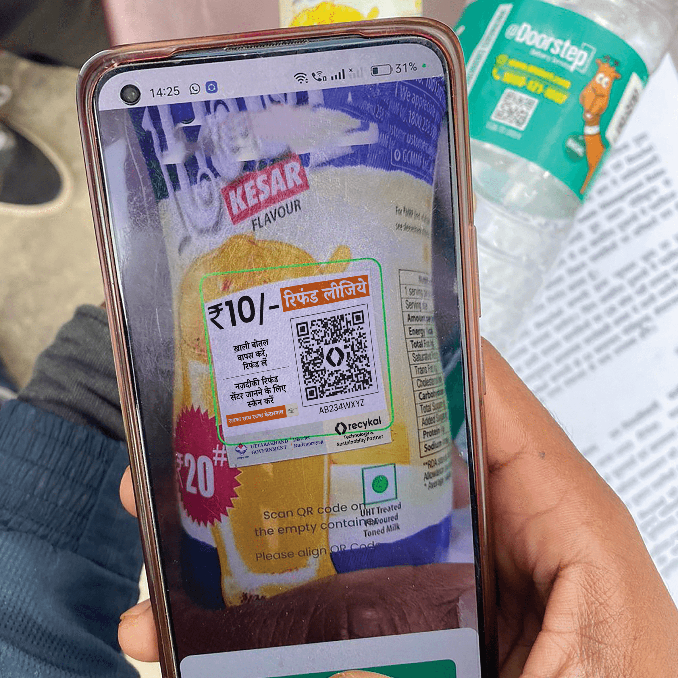 Woman in red outfit poses by a red telephone booth.