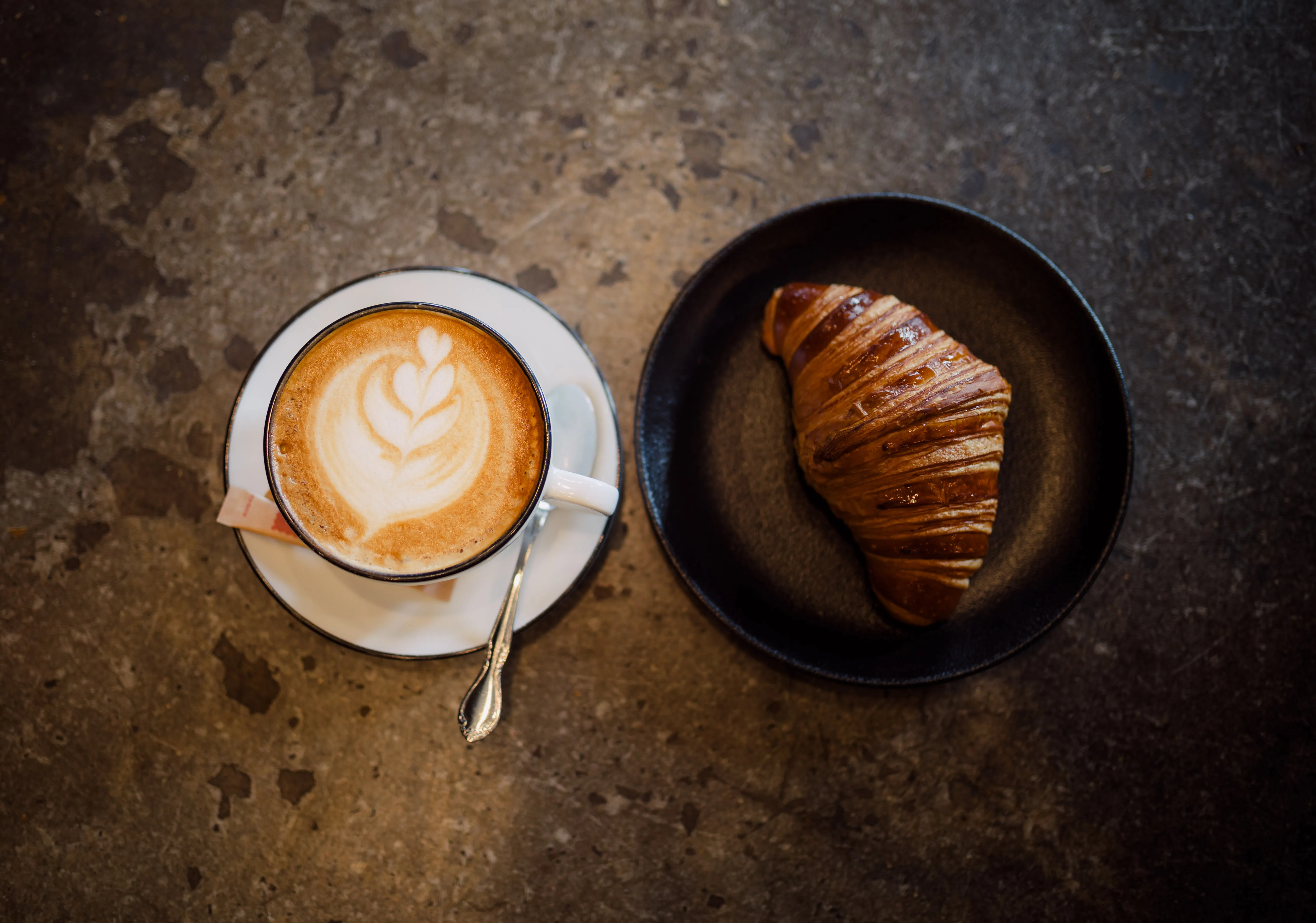 Pain d'Avignon café and bakery —fresh plain croissant and latte coffee