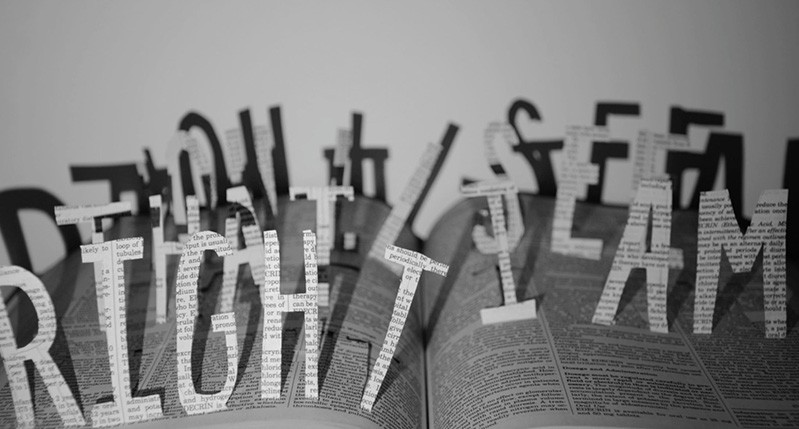 letter cut from book with shadow