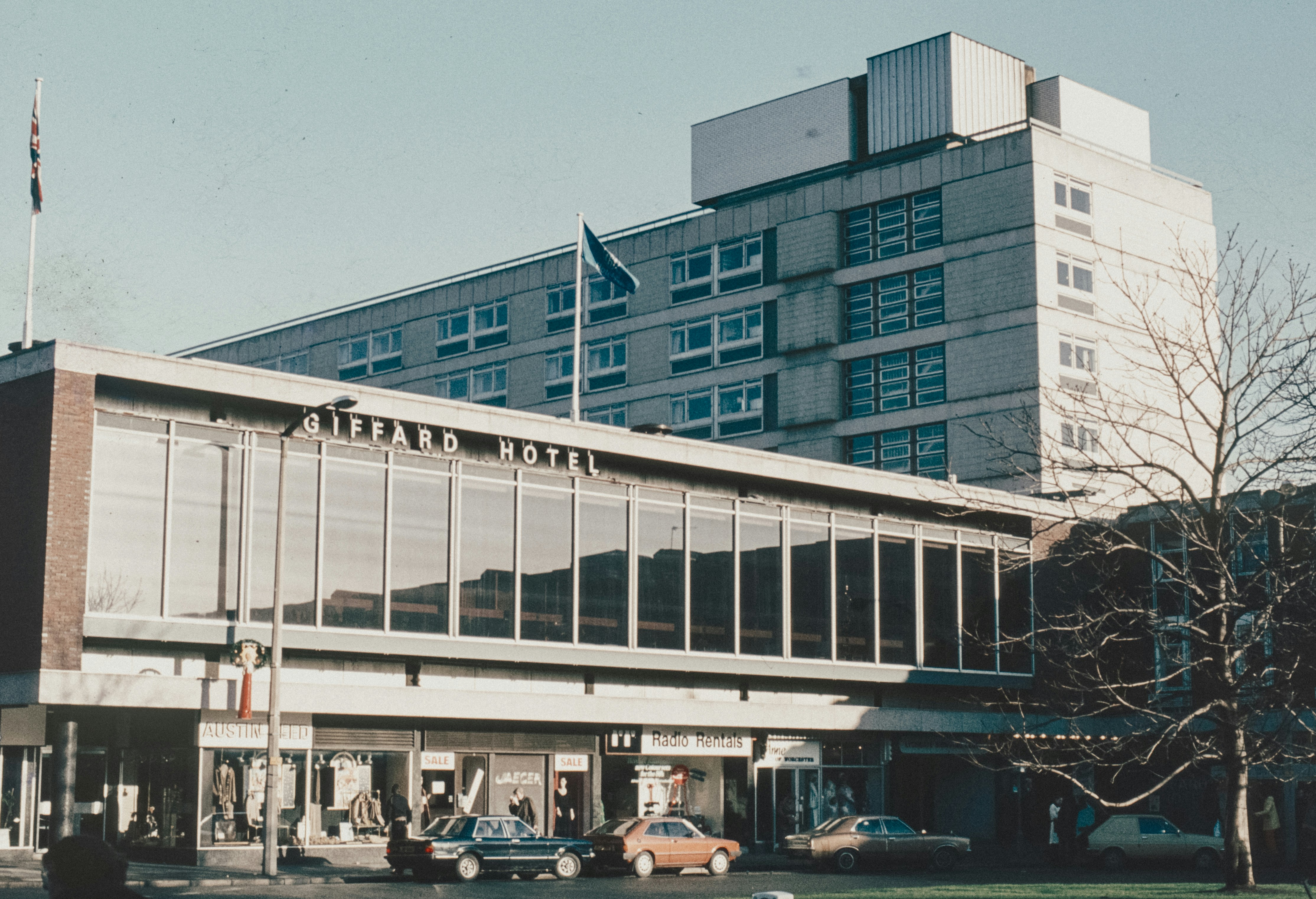 a large building with cars parked in front of it