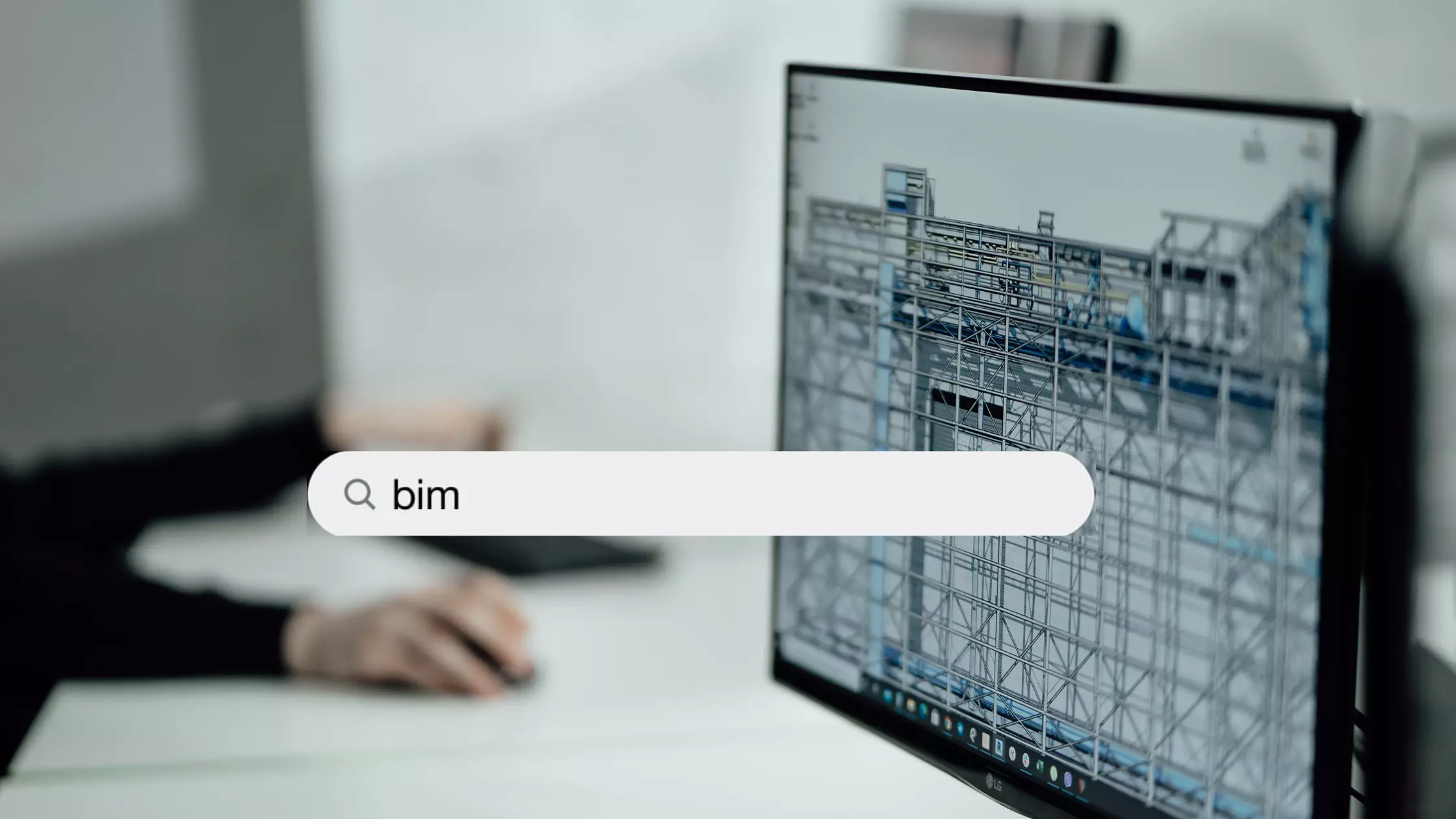 A man stands while two people sit at a table in an office setting, smiling and engaged in conversation. The mood is friendly and collaborative.