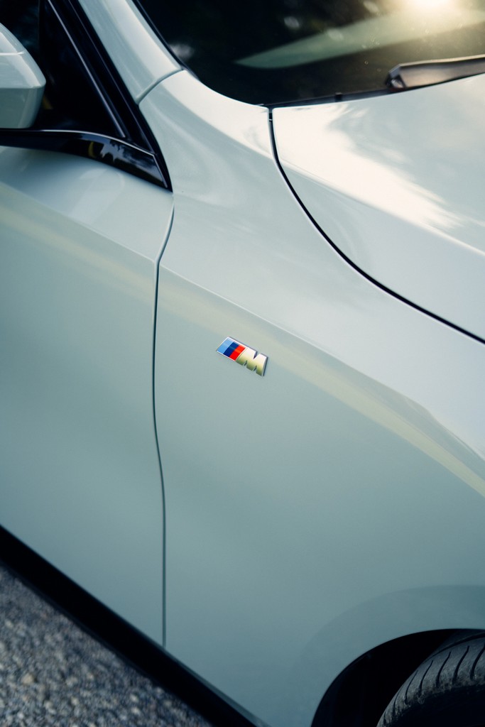 Detail shot of a BMW i5 badge and rear design