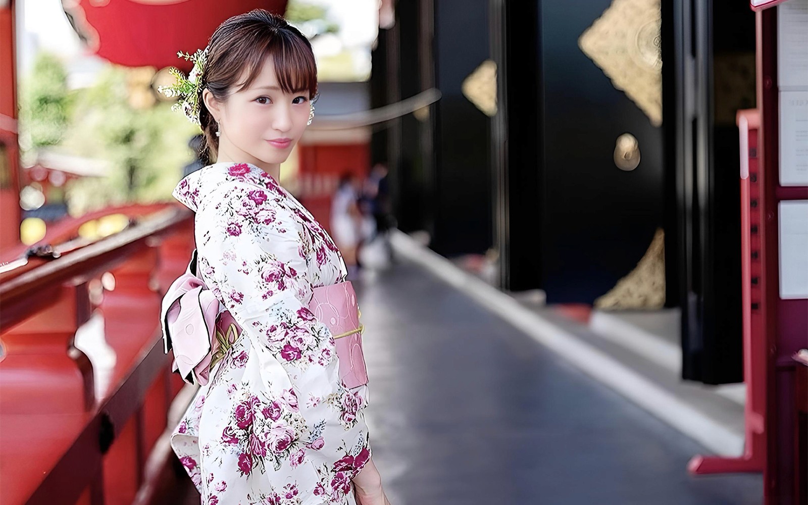 Person in traditional kimono walking through Asakusa, Tokyo, with Senso-ji Temple in the background.