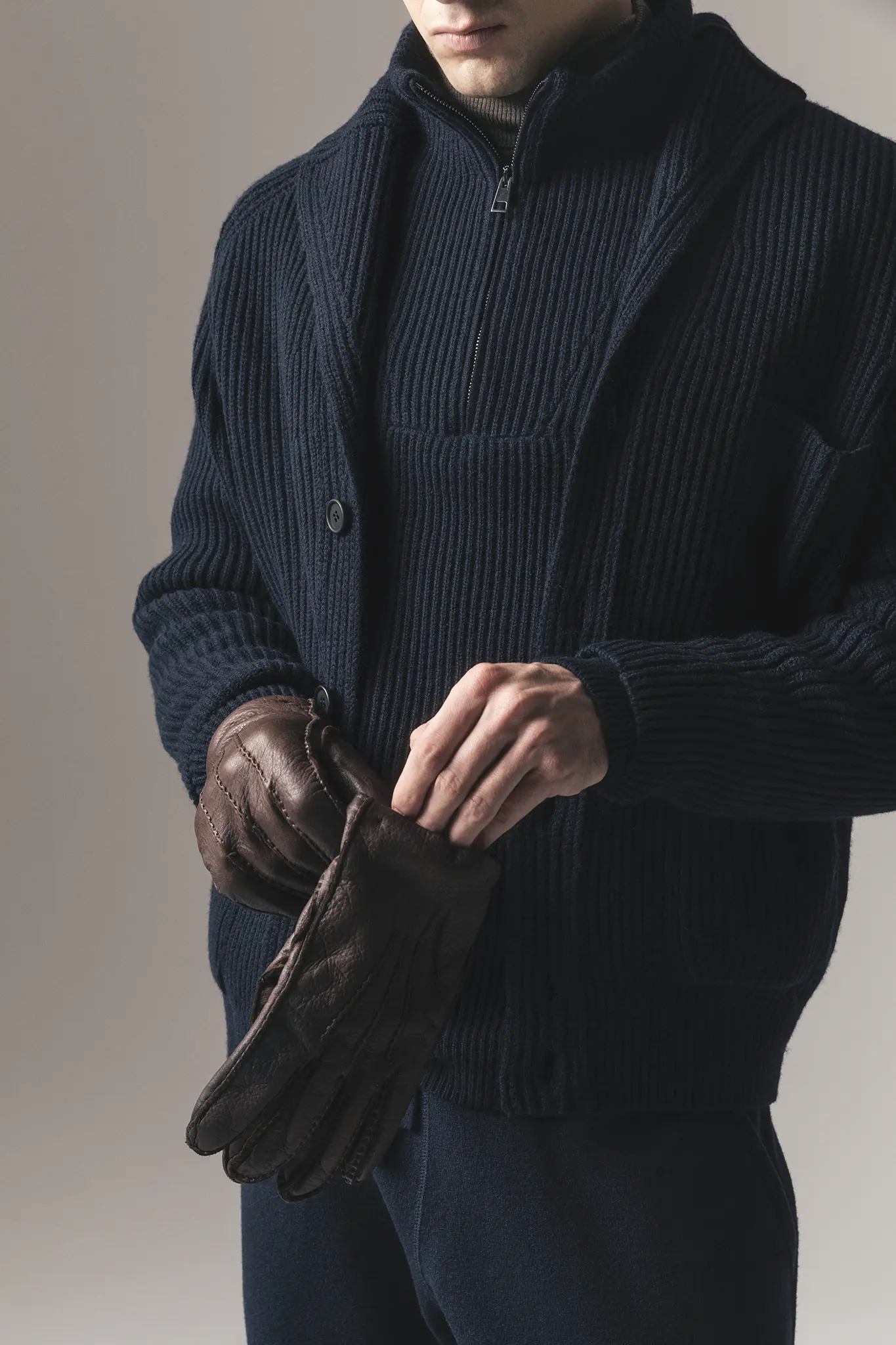 Detail of navy ribbed cashmere cardigan and leather gloves – Aida Barni men’s FW25/26.