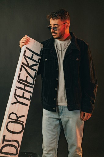 Man holding a sign with text on it