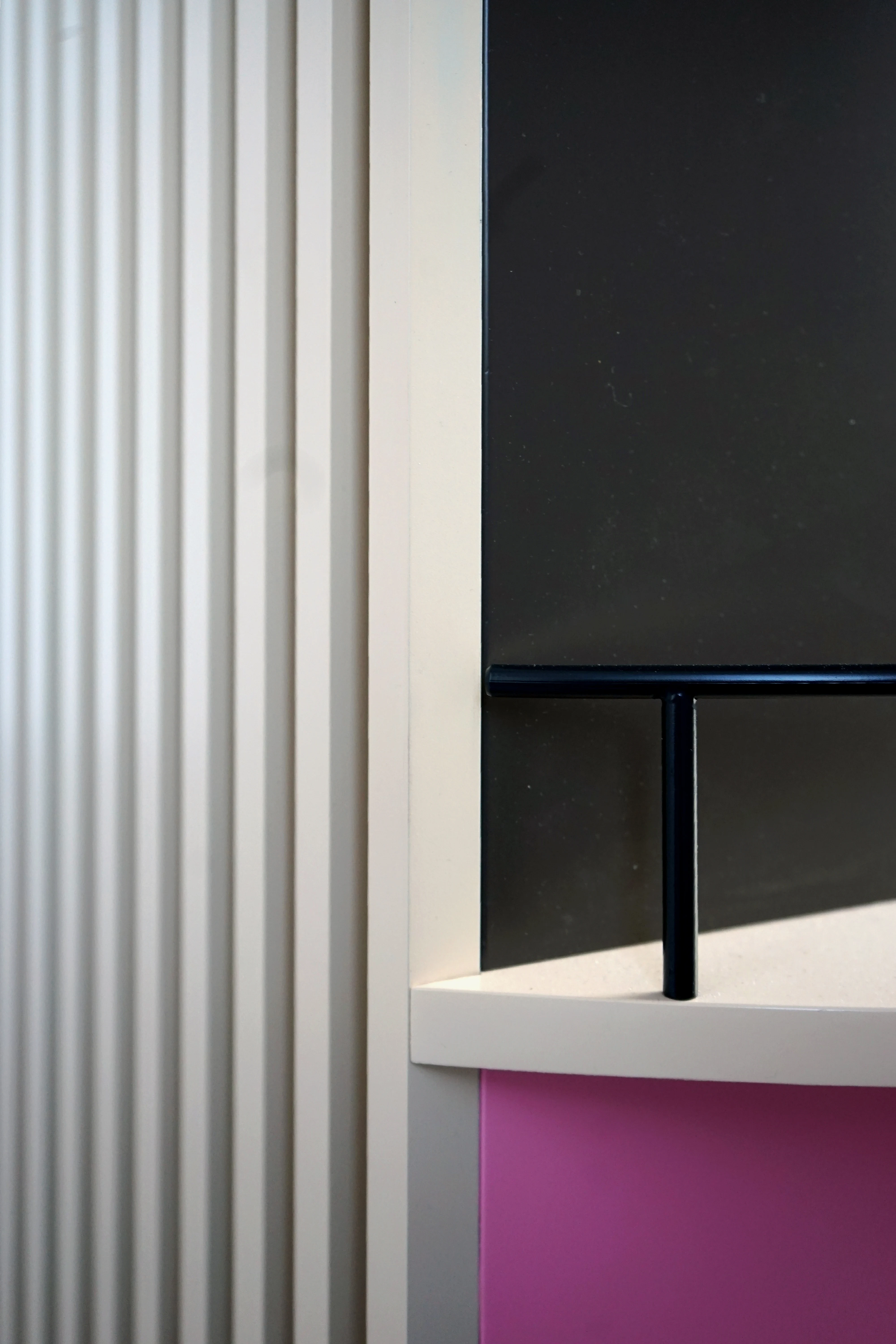 Material detail of the BAILEYS Treatbar with cream fluted panel, black tabletop, pink front and black tube frame.