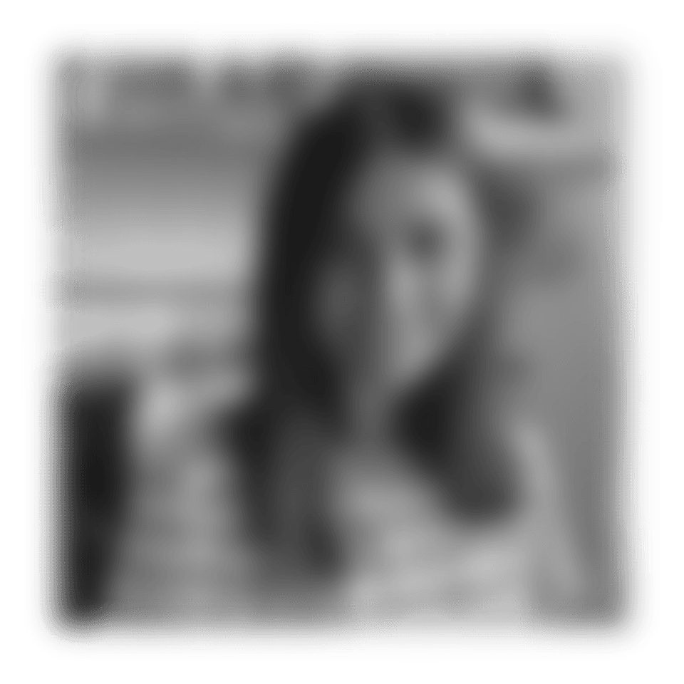 a woman with grey hair smiling at the camera