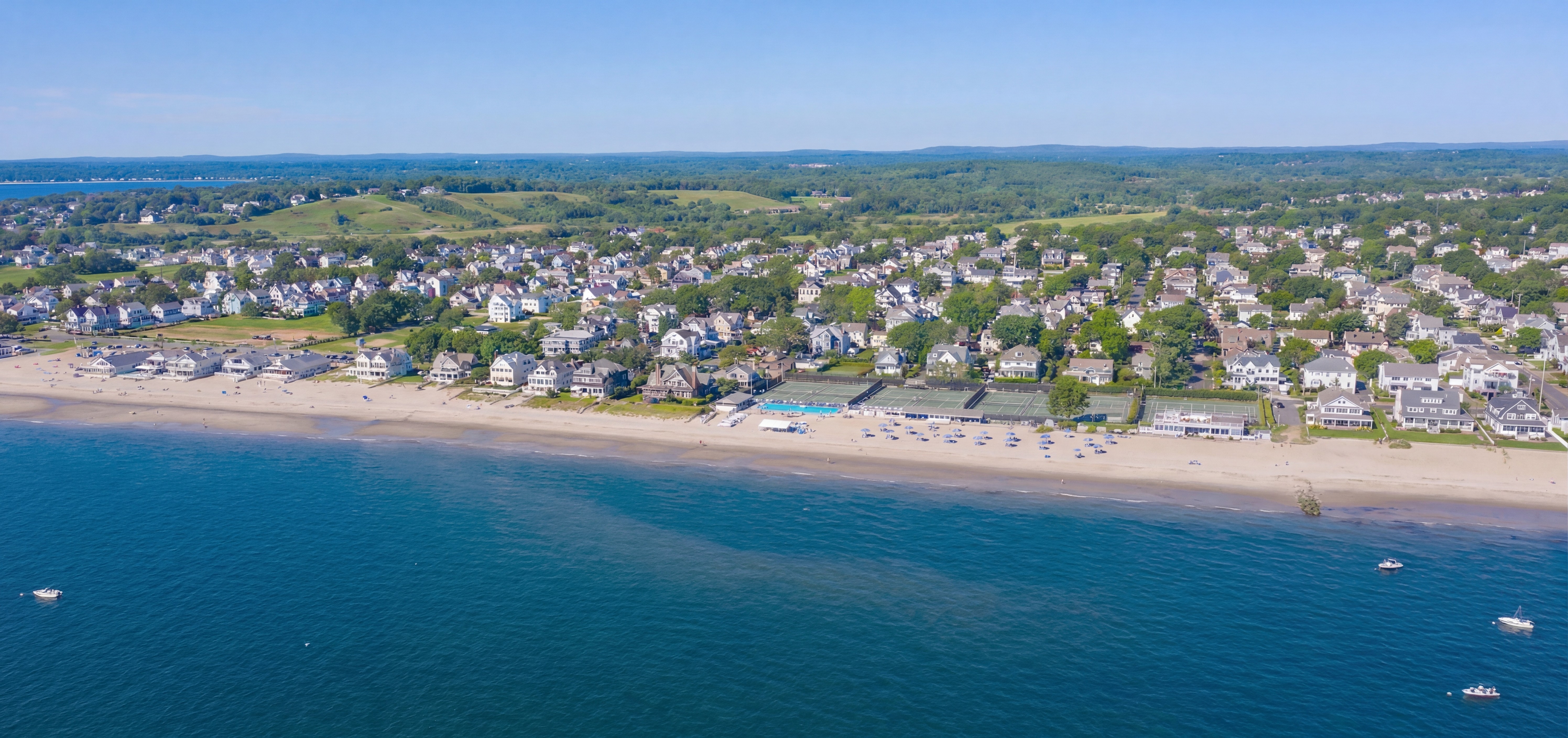 Aerial view of coast line with many houses and neighborhoods in view.
