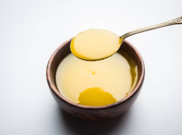 fresh desi ghee in a wooden bowl with a spoon
