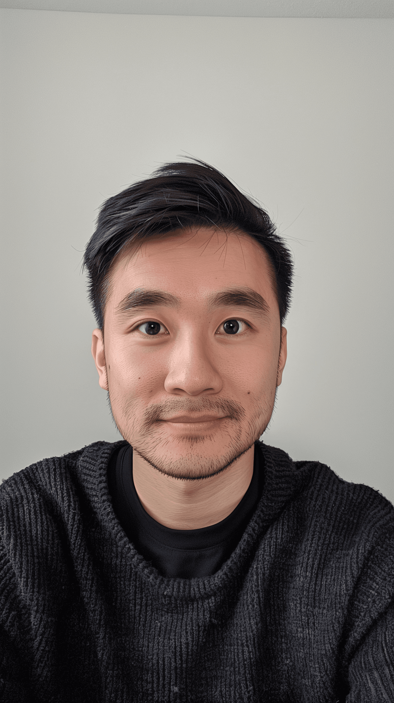 Portrait of Daniel Okoro, VP of AI Research, with dark hair in a charcoal sweater