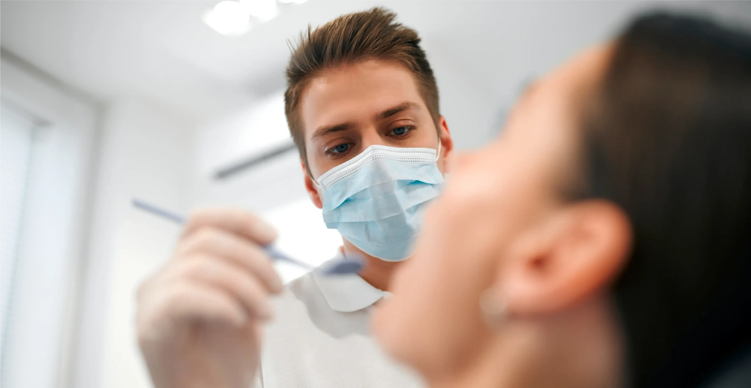 Kobieta z uśmiechem prezentująca efekty bondingu na swoich zębach.