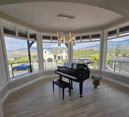 woman in blue jacket and blue denim jeans standing on brown wooden bridge