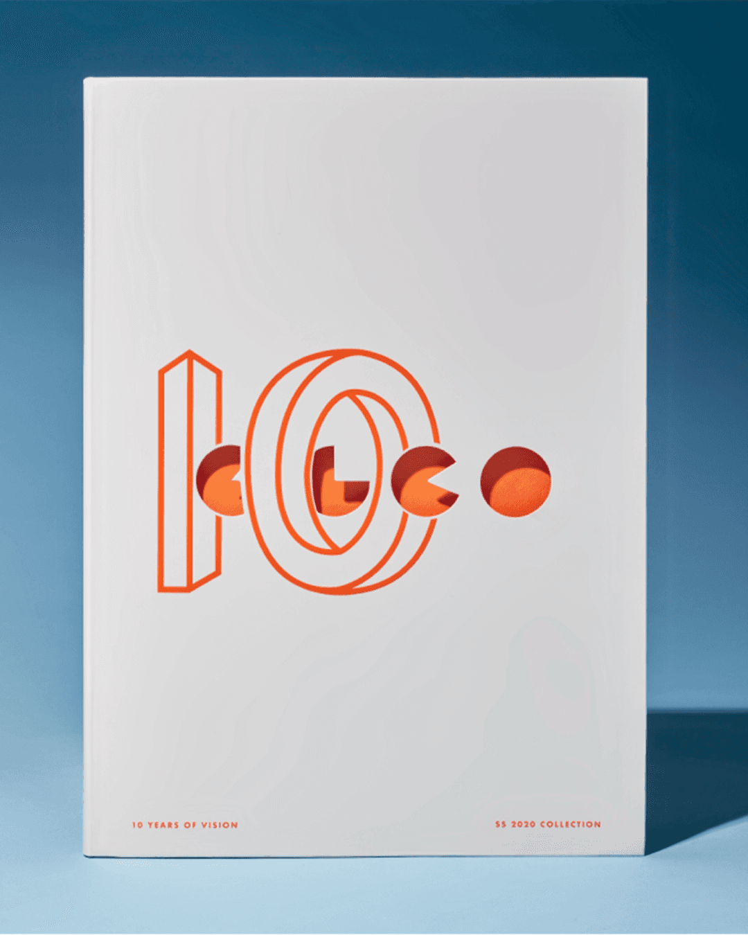 Garrett Leight anniversary campaign poster showing the "Ten Years of Vision" typographic treatment in bold orange on white