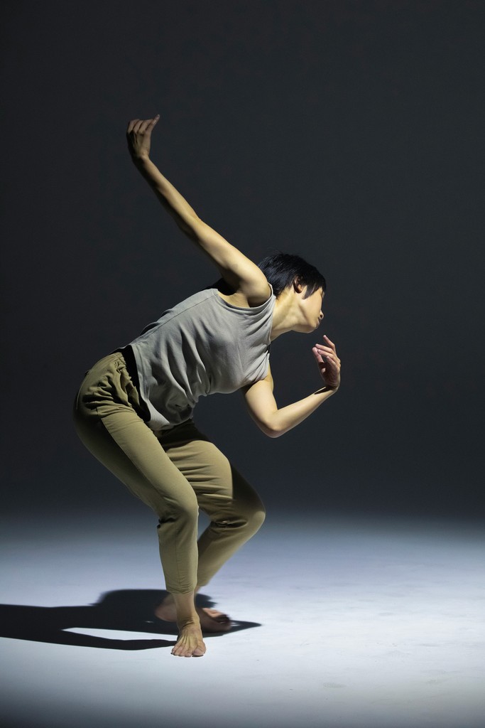 a man is doing a dance move in the dark