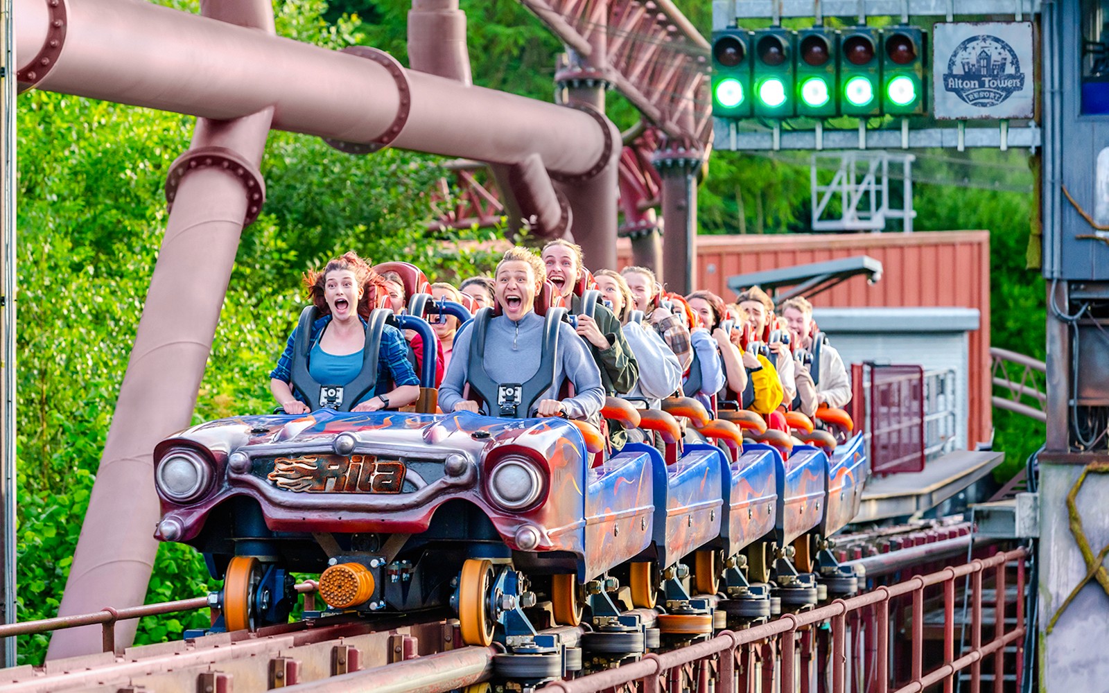 Riders on Rita rollercoaster at Alton Towers, UK, experiencing high-speed thrills.
