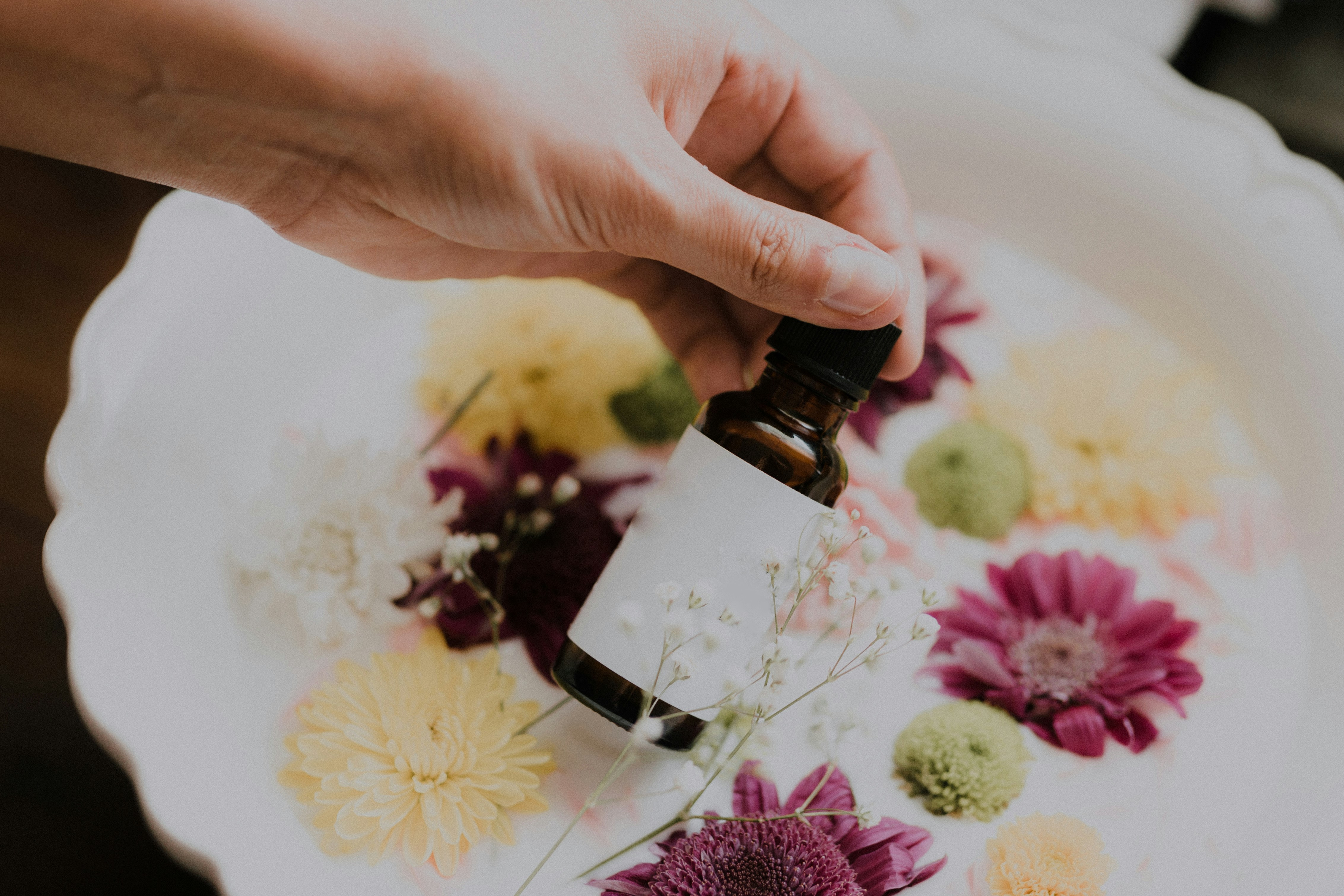 woman holding a bottle - When To Use Retinol In Skincare Routine