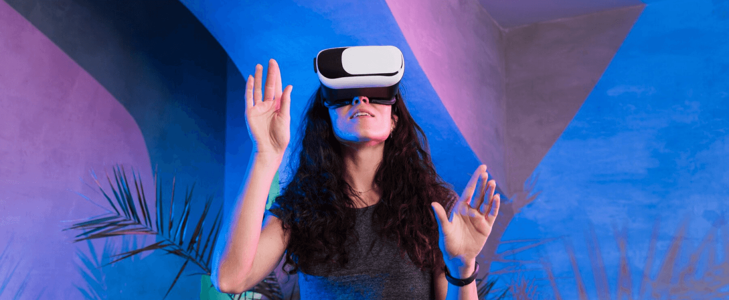 A girl wearing a VR headset, immersed in a virtual world, symbolizing the future of AR, VR, VT, and MR for 'The New Reality' blog