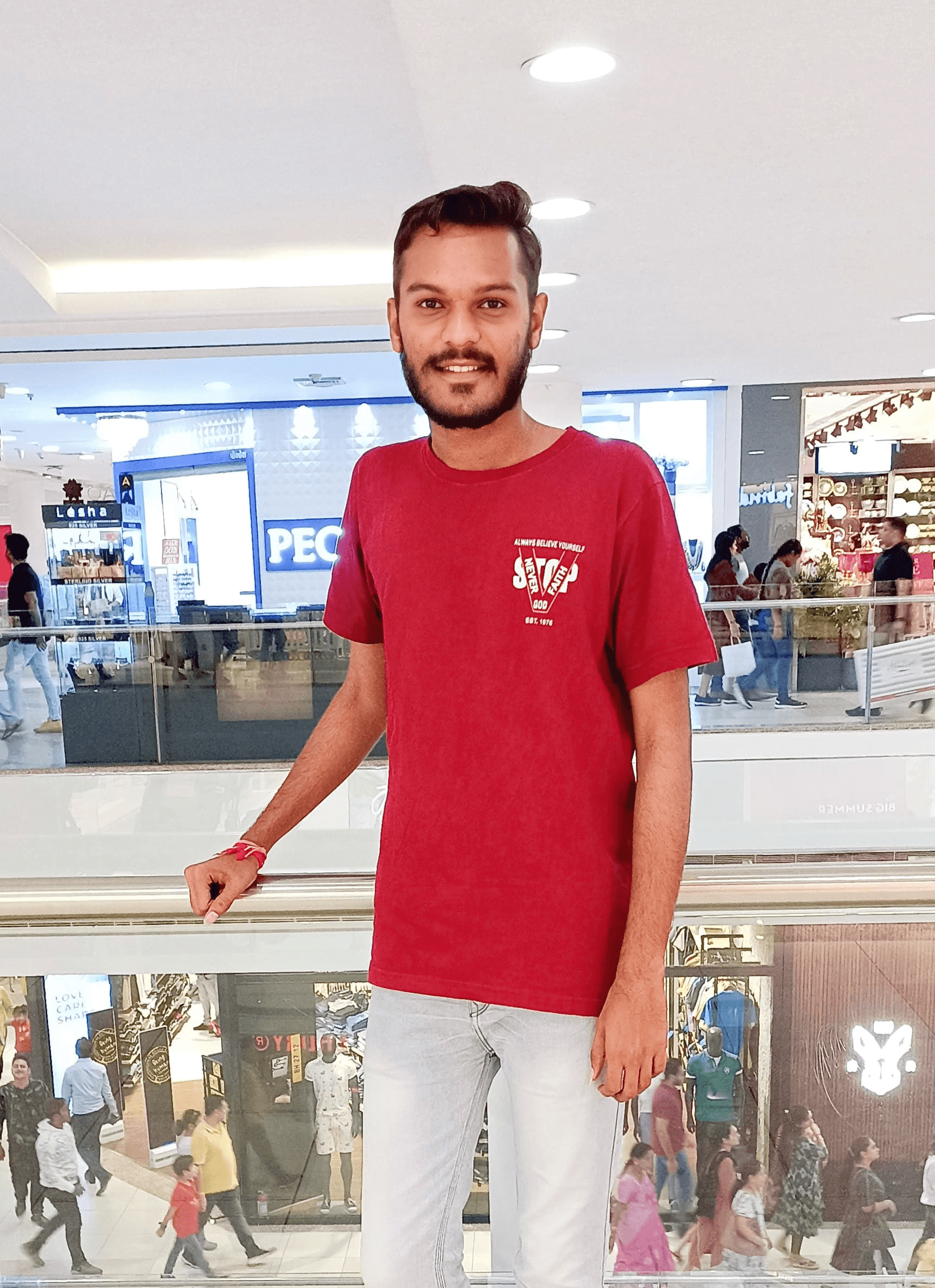 Portrait of a laughing person with curly hair wearing a white shirt