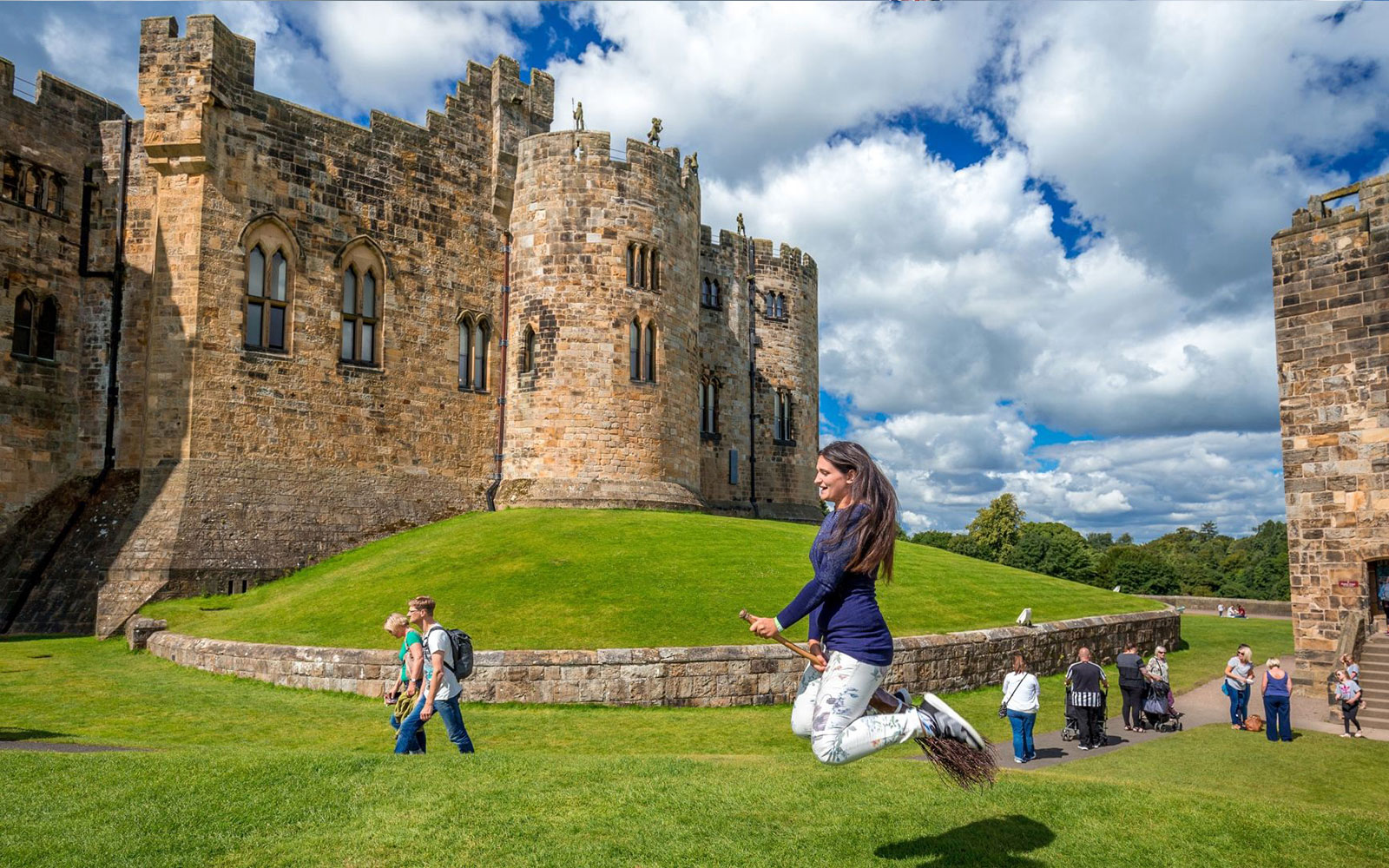 Woman practicing broomstick flying at Alnwick Castle, England.