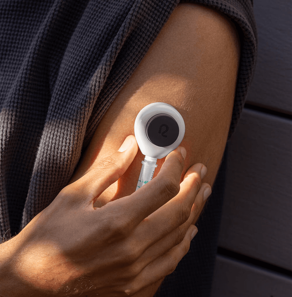 Person collecting a blood sample from their upper arm at home.
