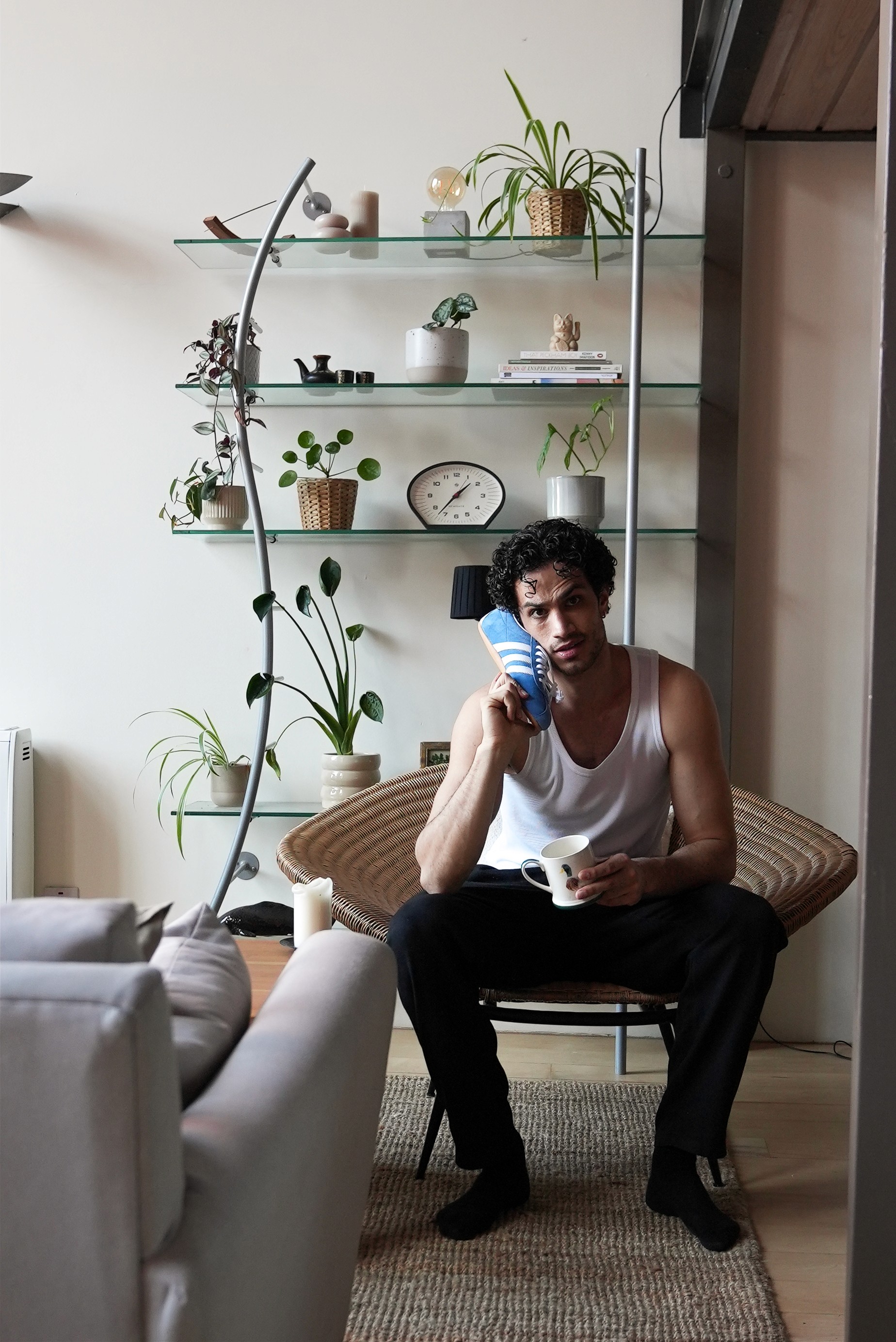 Person's hand petting Shiba Inu dog among fallen leaves