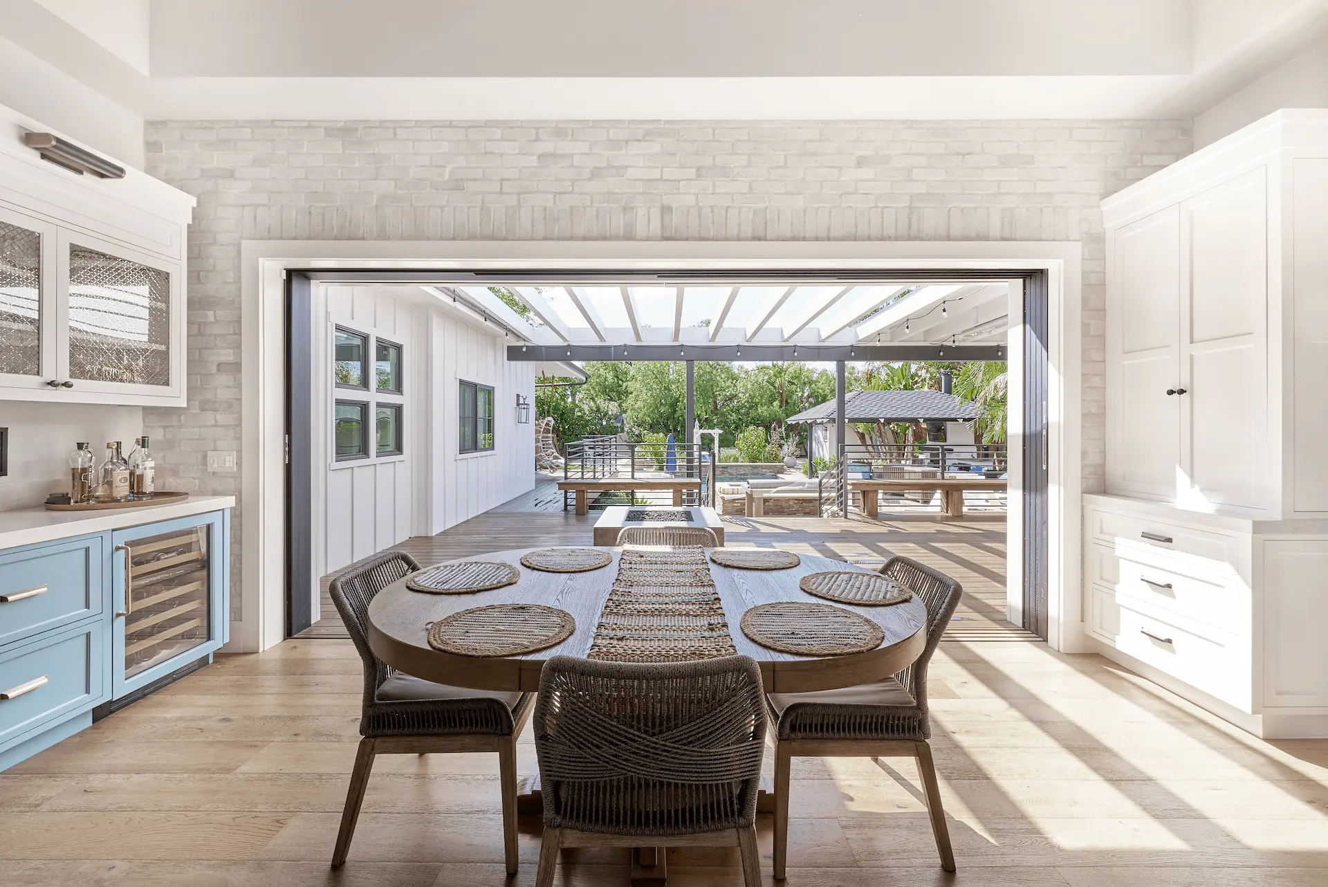 Dining area with retractable wall opening to outdoor space in North Tustin Remodel & Addition. Photo by Todd Huge.