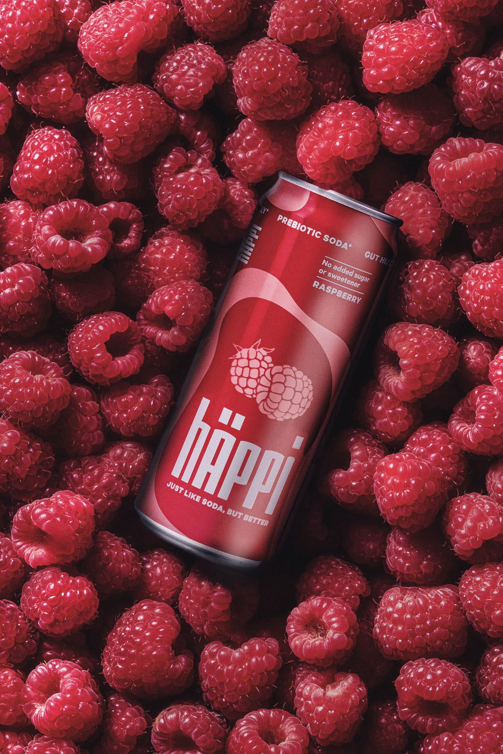 Dose Häppi Himbeer liegt auf Himbeeren