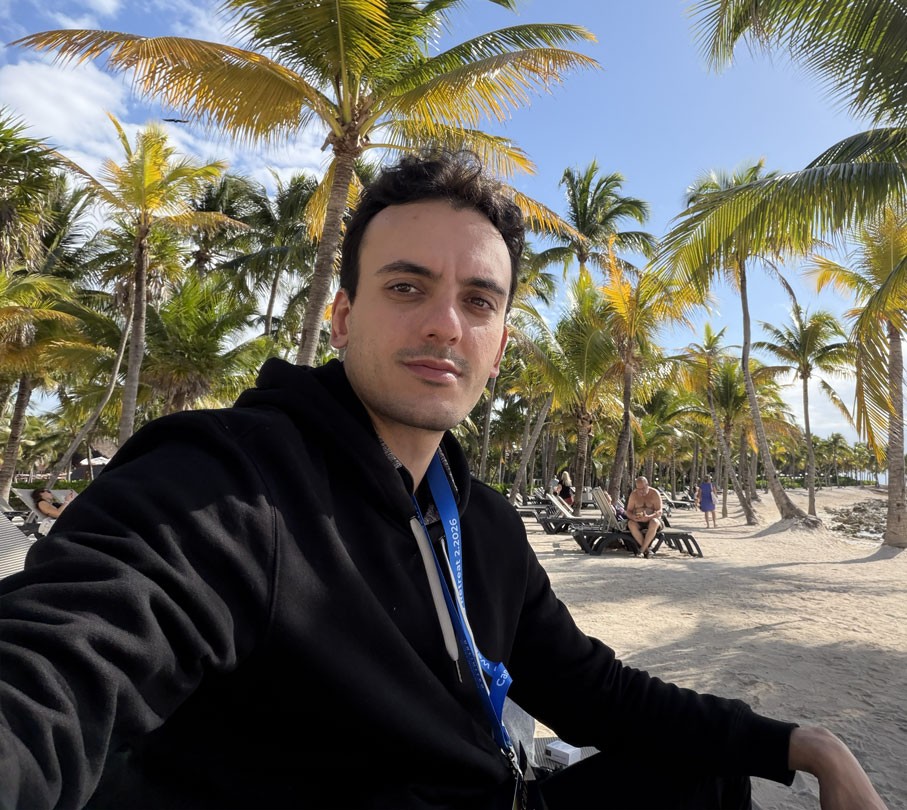 Portrait of a person in dark clothing speaking on a phone