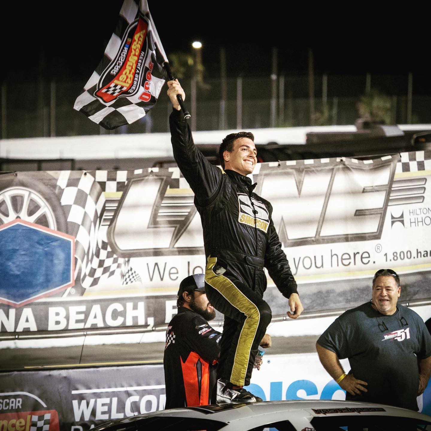 Stephen Nasse Holding a Checkered flag at New Symrna Speedway