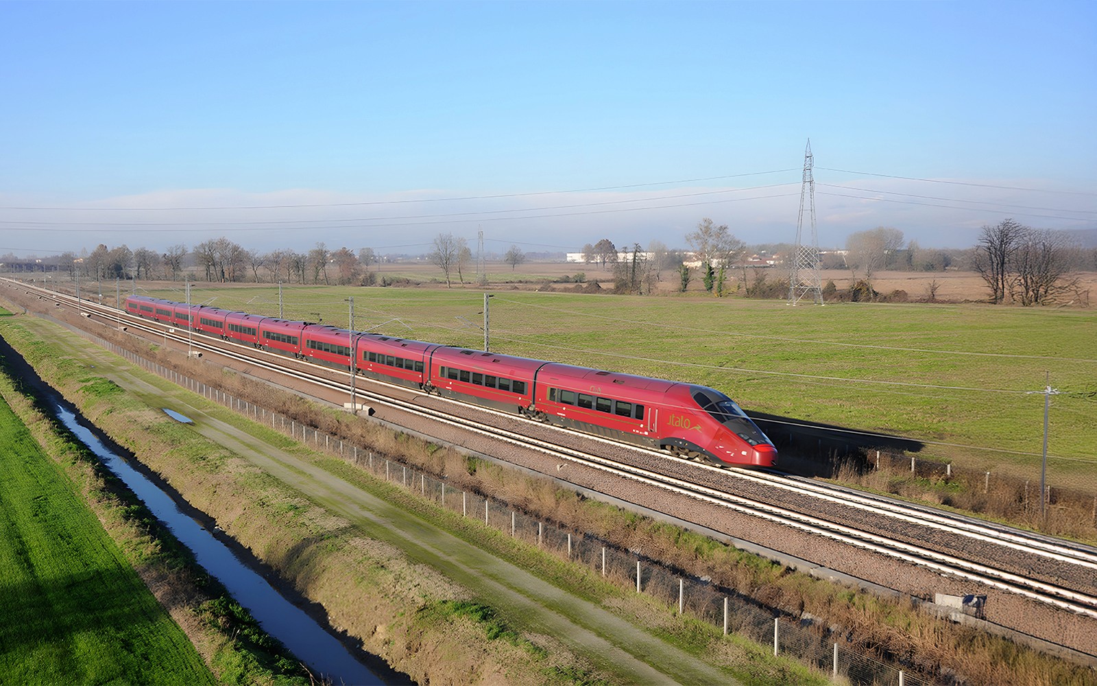 High-speed train traveling through countryside between Rome and Florence.